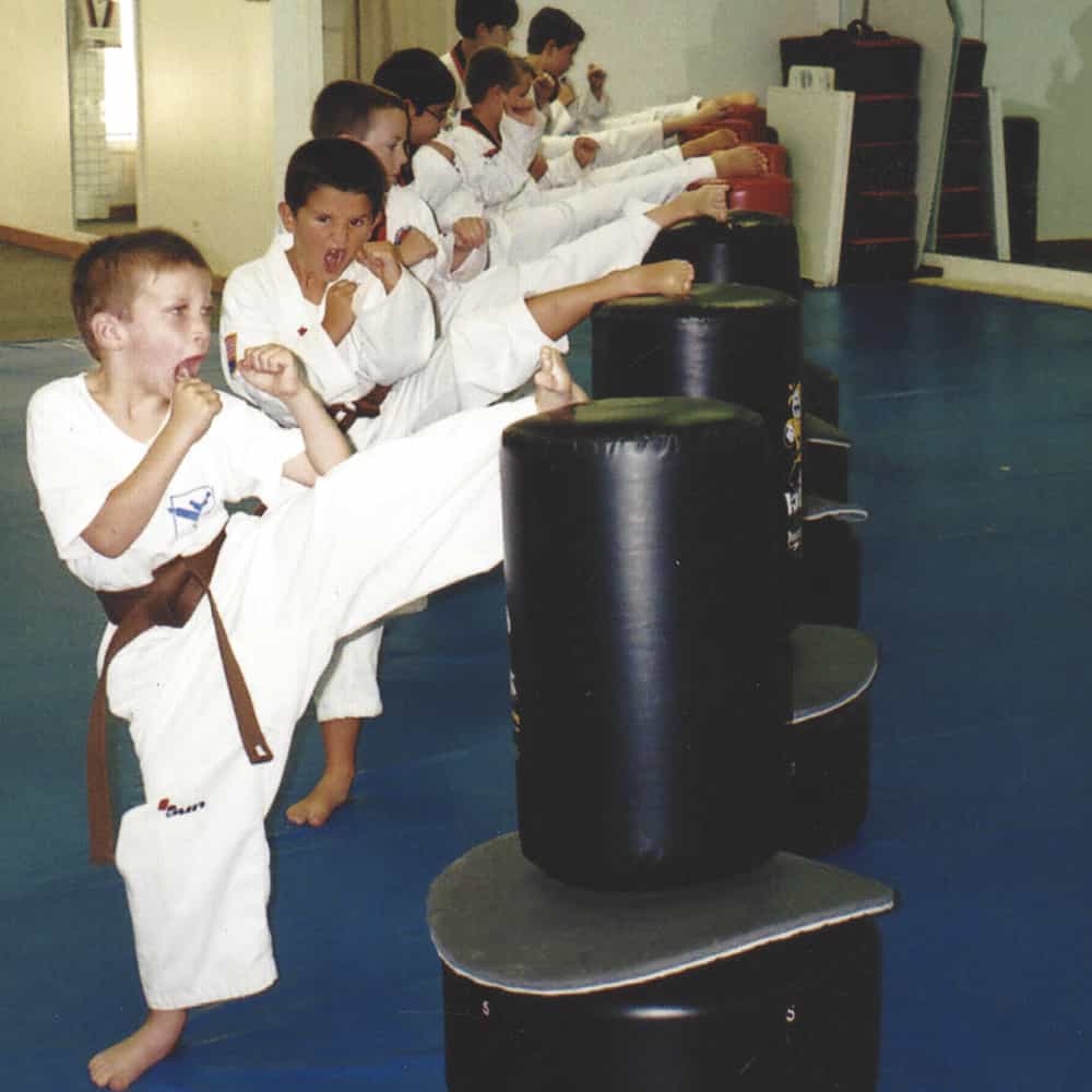 Line of kids showing their confident kicks